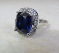 18ct white gold ring set with a single 11ct blue sapphire (13 x 11 x 7 mm) and approximately 1.