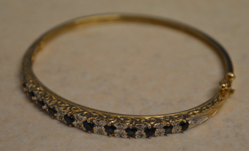 9ct gold sapphire and diamond bangle, set with approx 0.11ct of diamonds, total approx weight 11.