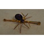 9ct gold bar brooch in the form of a spider set with two amethyst style stones to the body,