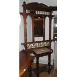 An early 20th century oak hall stand with mirror back, marble top, drawer and tiles, 42" wide