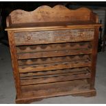 A pine wine rack, fitted one drawer over shaped shelves, on block base, 40" wide