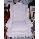 A wing armchair, upholstered in a cotton ticking with a grey linen loose cover