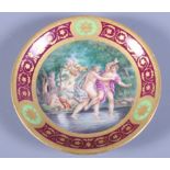 A mid 19th century Vienna porcelain saucer dish, decorated with semi-clad figures and cherubs by a