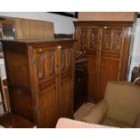 A carved oak bedroom suite comprising a dressing chest, fitted arch top mirror, a lady's wardrobe