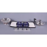 Four silver napkin rings, a silver plated teapot with half-spiral fluted decoration, a plated