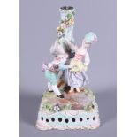A late 19th century Meissen porcelain figure candlestick, modelled in the form of two children