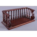 A mahogany book stand with spindle gallery and leaf carved scroll brackets, 16 1/2" wide
