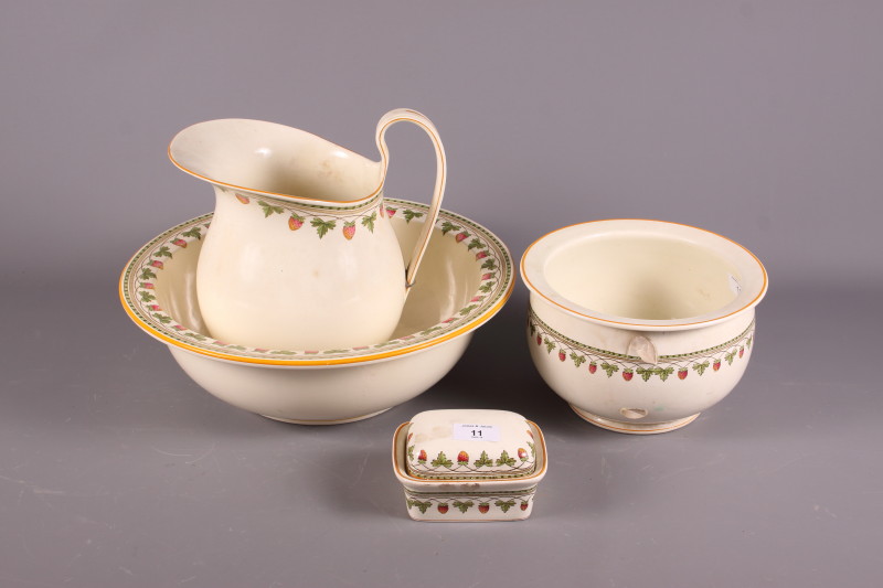 An early 20th century Wedgwood "Strawberry Fruit" toilet set, comprising jug and bowl, soap dish and