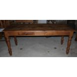 A waxed pine kitchen table, fitted two drawers, on turned supports, top 72" x 30"