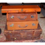 Three mid 20th century leather suitcases, together with a fitted leather gun case