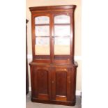 A 19th century mahogany bookcase, the upper section enclosed two arch top glazed panel doors over