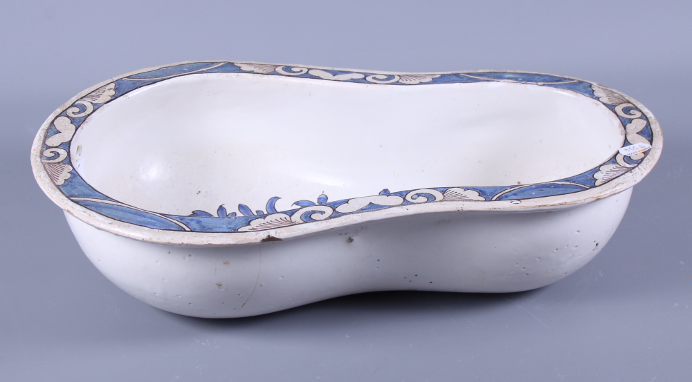 A French 19th century faience painted bidet liner, decorated blue painted flowers on a white ground,