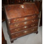 A late 18th century/early 19th century oak fall front bureau, fitted four drawers with swing brass