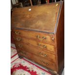 An Edwardian walnut and satinwood banded fall front bureau with fitted interior over four long