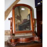 A Victorian walnut framed serpentine dressing table mirror, on shaped bracket supports