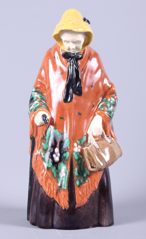 A Gmunder Keramik porcelain figure of an old lady, painted in bright colours, with original label,