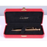 A gold plated propelling pencil and a Cartier rollerball pen