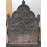 A cast iron fireback with 17th century figures and tree, 30" high