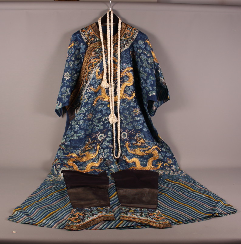 A Mandarin embroidered silk robe with dragons on a blue ground