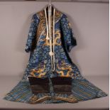 A Mandarin embroidered silk robe with dragons on a blue ground