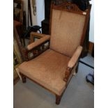 An Edwardian low seat open arm nursing chair, on turned supports