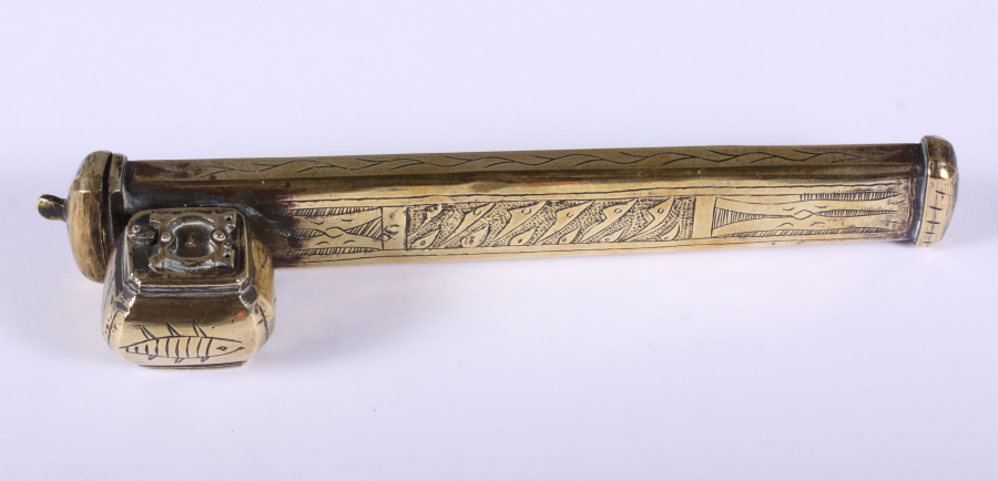 A late 19th century Indian brass pen and ink box, cast with abstract geometric decoration, 8" long