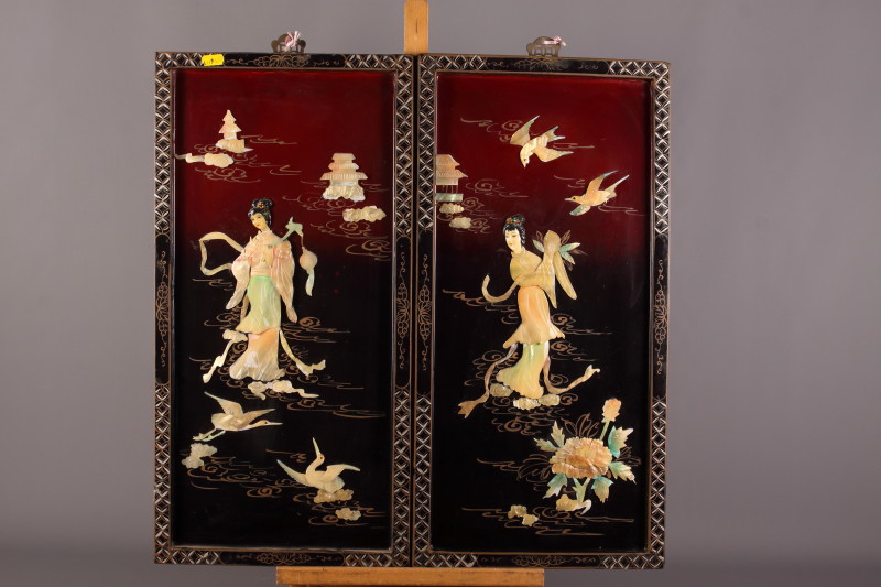 A set of four early 20th century Japanese hanging panels, each decorated with applied mother-of-