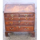 A late 18th/early 19th century inlaid walnut fall front bureau, fitted two short and three long