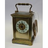 An early 20th century Pearce? & Sons of Paris brass carriage clock and an oil lamp