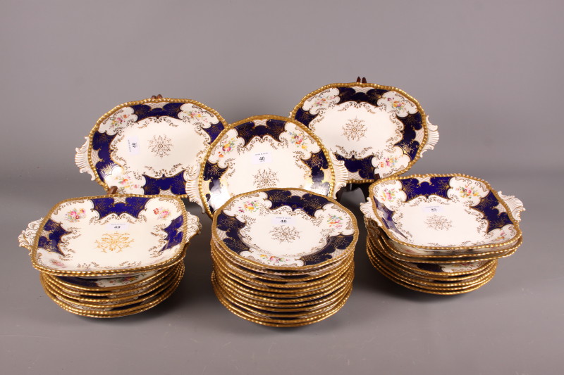 A late 19th century Coalport porcelain part dessert service with alternate panels of flowers and