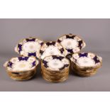 A late 19th century Coalport porcelain part dessert service with alternate panels of flowers and