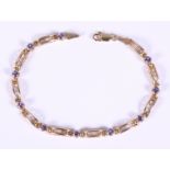 A Mexican marked as 10ct yellow gold and tanzanite bracelet, 8" long