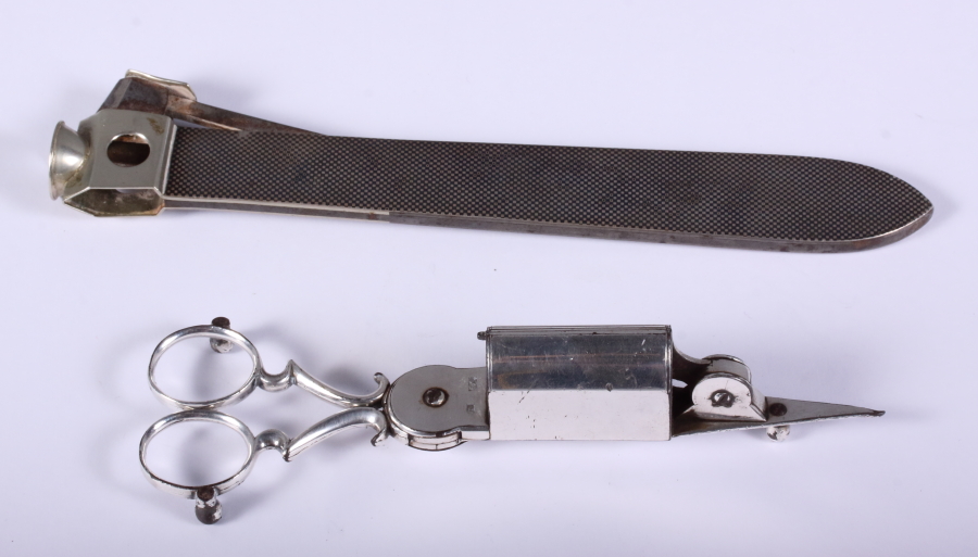 An early 20th century nielloware cigar cutter, 9" long, and a pair of late Victorian silver plate