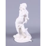 A 19th century, possibly Meissen, blanc-de-chine porcelain figure of a standing man holding a baby