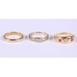 An 18ct gold ruby and diamond gypsy ring, an 18ct yellow and white gold diamond ring and an 18ct
