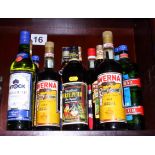 A collection of twelve bottles of various alcohol, including Vermouth, etc