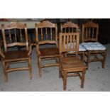 A set of four French design kitchen chairs with spindle backs and panel seats and a similar side