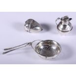 A Georgian silver tea strainer, Elizabeth Morley, London 1812, a child's silver rattle, in the