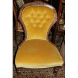A late 19th century polished as walnut showframe low seat nursing chair, button upholstered in an
