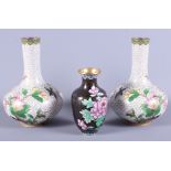 A pair of early 20th century Japanese cloisonne bottle vases, decorated birds and blossom on a white