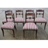 A set of six late Regency mahogany standard dining chairs with pierced bar backs and stuffed over