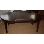 An early 20th century polished as mahogany wind-out dining table with two additional leaves, on