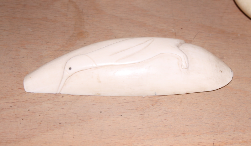 A collection of various sperm whale scrimshaw carvings a carved ivory cane handle with silver collar - Image 10 of 18