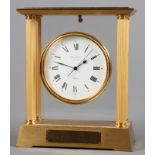 A gilt brass cased mantel clock with quartz movement and enamelled dial by Jean Roulet, 9 1/2" high