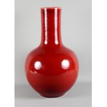 A 19th century Chinese porcelain bulbous vase decorated sang de boeuf glaze, 19 1/2" high