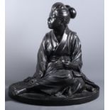 A 19th century Japanese bronze figure of a seated young geisha, signed, 21" high, on bamboo carved