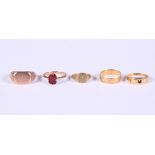 A 9ct gold signet ring, a smaller similar ring, a 9ct gold ring set redstone, 8.8g gross, and two