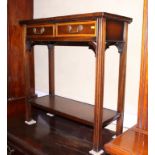 A mahogany and banded two-tier side table, fitted two drawers, on moulded supports, 30" wide