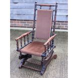 A polished as walnut American rocking chair, upholstered in a brown velour