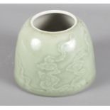 A Chinese porcelain celadon glazed brush pot decorated clouds with six character Guangxu mark to